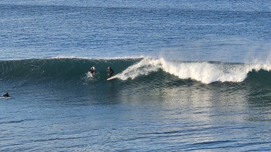 Surfer riding a clean right-hand wave at Banana Point near Aourir, Morocco