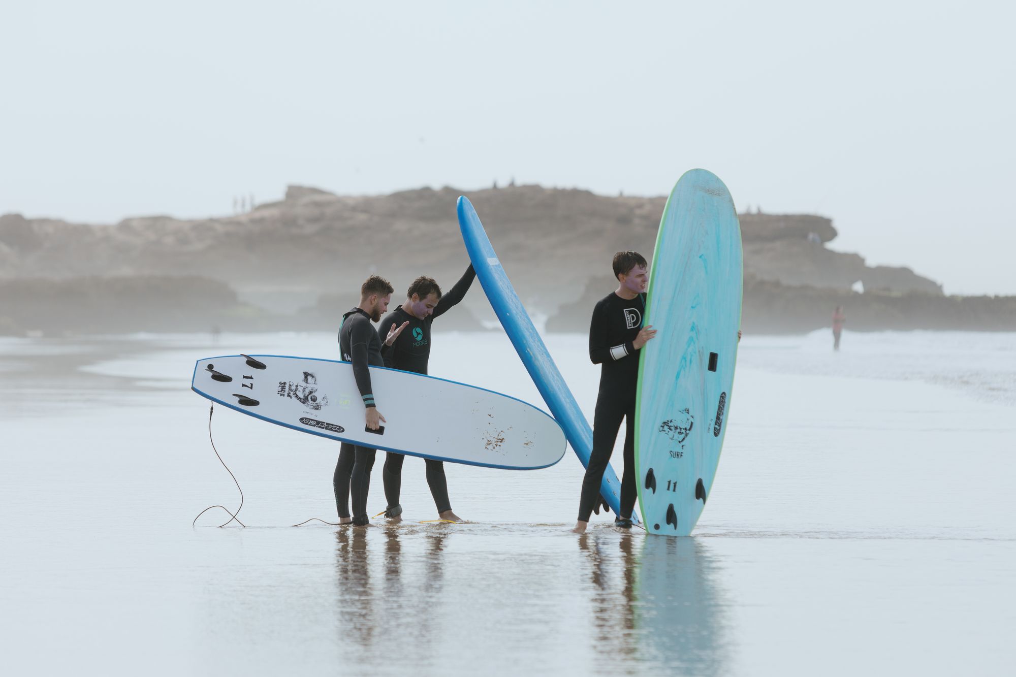 surfers with boards misty beach tamraght | Twist Surf
